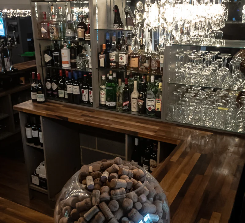 Wines and glasses behind the bar